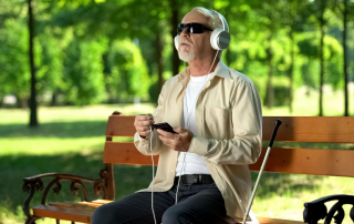 old blind man with headphones