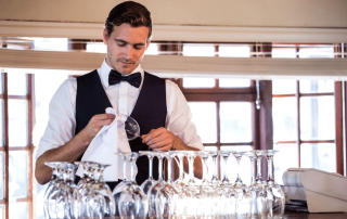 bartender cleaning wineglass
